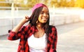 Cool girl having fun in the city park, wearing a red checkered shirt Royalty Free Stock Photo