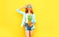 cool girl with pineapple blowing red lips sending sweet air kiss in summer straw hat, sunglasses, shorts on colorful yellow Royalty Free Stock Photo