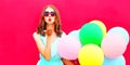 Cool girl is sends an air kiss holds an air colorful balloons Royalty Free Stock Photo