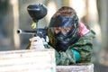 Cool girl shooting from paintball gun. Closeup. Royalty Free Stock Photo