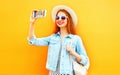 Cool girl woman takes a picture self portrait on a smartphone Royalty Free Stock Photo