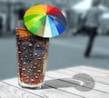 Cool glass cola coke drink with summer parasol umbella