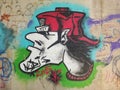 Cool graffiti under a bridge - head of a person with a red cap