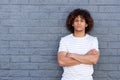 Cool guy against gray wall with arms crossed Royalty Free Stock Photo