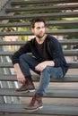 Cool guy in black clothing sitting on steps Royalty Free Stock Photo