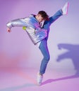 Cool guy dancing contemporary dance in studio. Neon light background. Acrobatic bboy dancer. Break dance lessons. Royalty Free Stock Photo