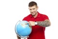 Cool guy holding and pointing at the globe Royalty Free Stock Photo