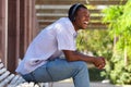 Cool guy laughing with headphones in park Royalty Free Stock Photo