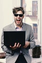 Cool guy sits on table and works. Working online concept Royalty Free Stock Photo