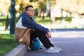 Cool guy sitting and relaxing outdoors during a break in class Royalty Free Stock Photo