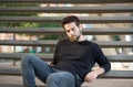 Cool guy sitting on steps outdoors Royalty Free Stock Photo