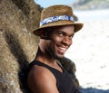 Cool guy smiling at the beach with hat Royalty Free Stock Photo