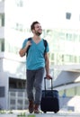 Cool guy smiling with suitcase and bag Royalty Free Stock Photo