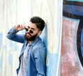 Cool guy with sunglasses listening to music with earphones Royalty Free Stock Photo