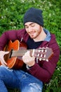 Cool handsome guy playing guitar at outside Royalty Free Stock Photo