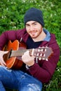 Cool handsome guy playing guitar at outside Royalty Free Stock Photo