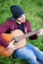 Cool handsome guy playing guitar at outside Royalty Free Stock Photo