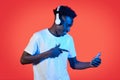 Cool black guy using wireless headset and smartphone Royalty Free Stock Photo