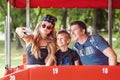 Cool and hipster modern family taking a selfie on a open-air buss during tour ride adventure Royalty Free Stock Photo