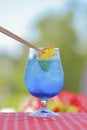 Cool ice soft blue drink with soda water, refreshing summer beverage. Alcohol cocktail with ice in a glass outside Royalty Free Stock Photo