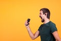 Cool joyful young man listening music in his headphones Royalty Free Stock Photo