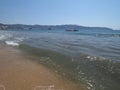 Cool landscape of sandy beach at bay of ACAPULCO city in Mexico with motor boat and waves of Pacific Ocean Royalty Free Stock Photo
