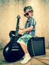 Cool little boy posing with electric guitar. Royalty Free Stock Photo