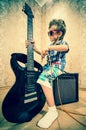 Cool little boy posing with electric guitar. Royalty Free Stock Photo