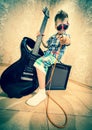 Cool little boy posing with electric guitar. Royalty Free Stock Photo