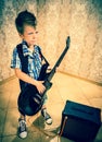 Cool little boy posing with electric guitar. Royalty Free Stock Photo