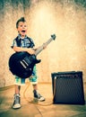 Cool little boy posing with electric guitar. Royalty Free Stock Photo