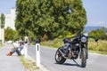 Motorcycle rider sitting near custom made scrambler style cafe r Royalty Free Stock Photo