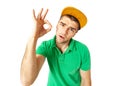 Cool looking young guy showing OK sign standing against white background