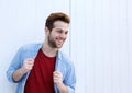 Cool male fashion model smiling against white background Royalty Free Stock Photo