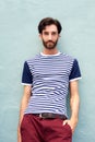 Cool male model in striped shirt leaning against wall Royalty Free Stock Photo