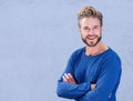 Cool man with beard smiling with arms crossed