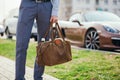 Cool man beautiful model outdoors, city style fashion. A handsome man model walking in the city center next to some cars Royalty Free Stock Photo