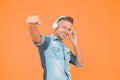 cool man enjoy music. his favorite playlist. dj party. happy man dancing yellow background. listen to music in