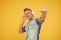 Cool man enjoy music. his favorite playlist. dj party. happy man dancing yellow background. listen to music in