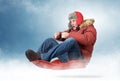 Cool man fly on a sled in the snow Royalty Free Stock Photo