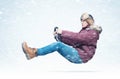 Cool man in red winter clothes and hat is driving a car with a steering wheel, in snow and blizzard. Royalty Free Stock Photo