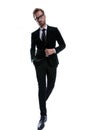 Cool man buttoning black suit while holding hand in pocket Royalty Free Stock Photo