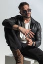 Cool man with wet hair wearing black leather jacket and sunglasses Royalty Free Stock Photo