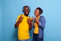 Cool man and woman showing rock sign with fingers on camera Royalty Free Stock Photo