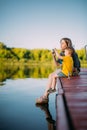 Cool mother and baby boy sitting on dock launch soap bubbles. Summer photography for blog or ad about family and travel