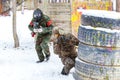 Cool paintball in winter. Two shooters behind fortifications. Royalty Free Stock Photo