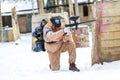 Cool paintball in winter. Two shooters behind fortifications. Royalty Free Stock Photo