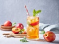 Cool peach tea with mint and ice in a glass on a blue background. Front view and copy space Royalty Free Stock Photo