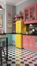 A cool pop-art inspired kitchen with bright, eye-catching appliances and retro furnishings