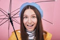 Cool surprised girl in yellow rain jacket with umbrella Royalty Free Stock Photo